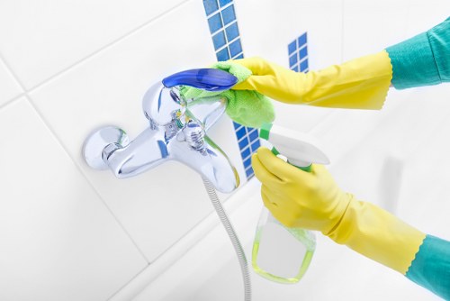 Cleaner wearing PPE during a carpet cleaning job